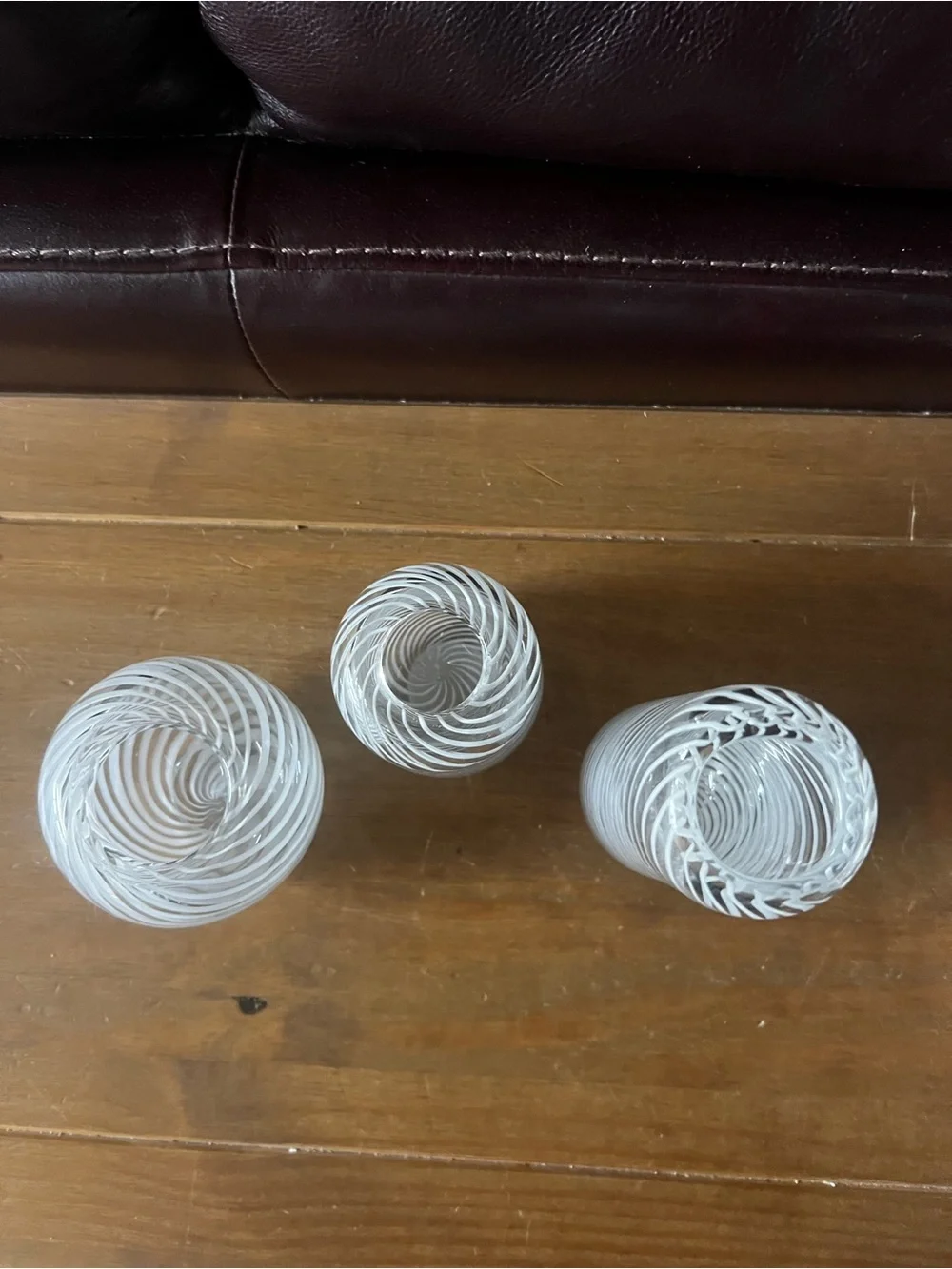 Set of three hand blown vases. Beautiful with white swirls.